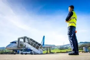 Ein Security-Mitarbeiter des Airports St. Gallen-Altenrhein überwacht das Vorfeld während die Embraer 170 der People’s Vienna Line auf ihren nächsten Flug in Richtung Wien wartet.